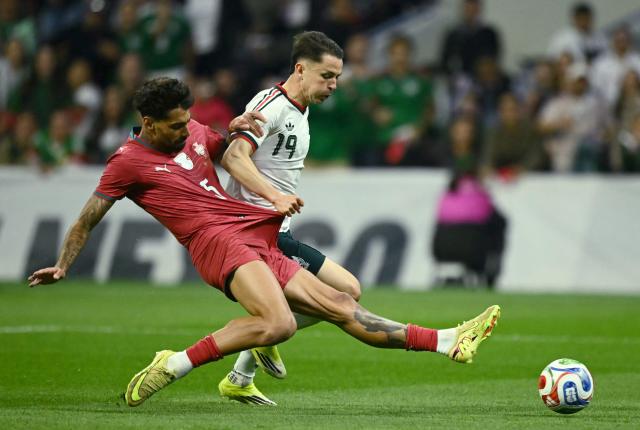 Portugal's defender #05 Samu Costa and Mexico's midfielder #19 Alvaro Fidalgo fight for the ball during a friendly football match between Mexico and Portugal at the Banorte (formerly known as Azteca) Stadium in Mexico City on March 28, 2026. (Photo by CARL DE SOUZA / AFP)