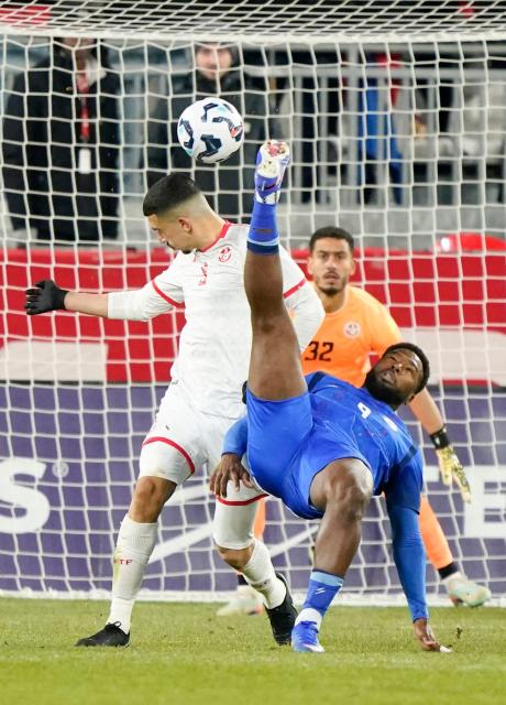 Tunisia's goalkeeper #32 Sabri Ben Hessen looks on as Tunisia's defender #05 Adem Arous attempts to block Haiti's forward #09 Duckens Nazon during a friendly football match between Haiti and Tunisia at BMO Field in Toronto, Canada, on March 28, 2026. (Photo by Geoff Robins / AFP)