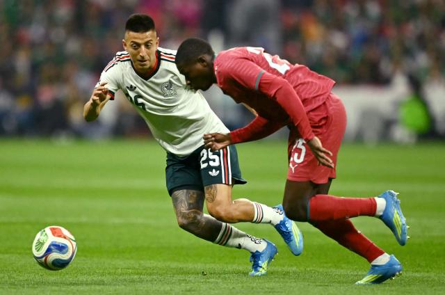 Mexico's midfielder #25 Roberto Alvarado (L) and Portugal's defender #25 Nuno Mendes (R) fight for the ball during a friendly football match between Mexico and Portugal at the Banorte (formerly known as Azteca) Stadium in Mexico City on March 28, 2026. (Photo by CARL DE SOUZA / AFP)
