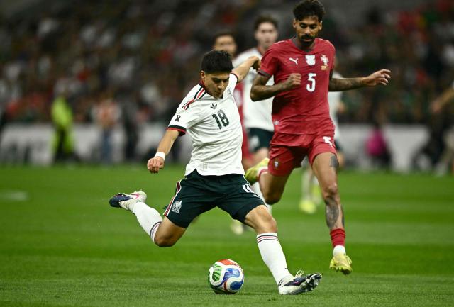 Mexico's midfielder #18 Obed Vargas kicks the ball past Portugal's defender #05 Samu Costa during a friendly football match between Mexico and Portugal at the Banorte (formerly known as Azteca) Stadium in Mexico City on March 28, 2026. (Photo by CARL DE SOUZA / AFP)