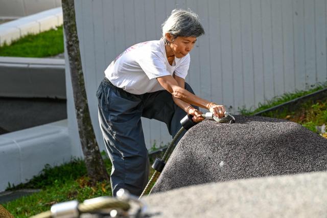 This photograph taken on March 17, 2026 shows a Singaporean elder taking part in a parkour training session in Singapore. This is "geriatric parkour", where around 20 retirees learned to tackle a series of relatively demanding exercises, building their agility and enjoying a sense of camaraderie. (Photo by Roslan RAHMAN / AFP) / To go with "Singapore-Ageism" Focus by Martin ABBUGAO