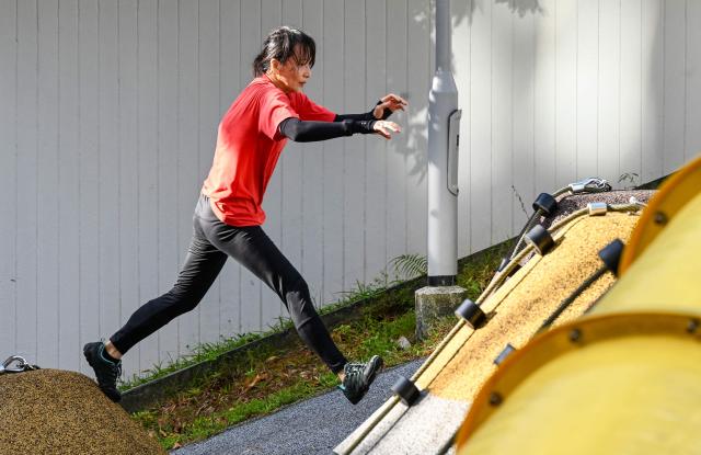 This photograph taken on March 17, 2026 shows a Singaporean elder taking part in a parkour training session in Singapore. This is "geriatric parkour", where around 20 retirees learned to tackle a series of relatively demanding exercises, building their agility and enjoying a sense of camaraderie. (Photo by Roslan RAHMAN / AFP) / To go with "Singapore-Ageism" Focus by Martin ABBUGAO