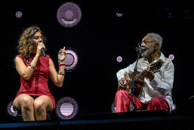 Brazilian musician and songwriter Gilberto Gil (R) performs with his granddaughter Flor Gil (L) on his 'Gil Tempo Rei Last tour' at Allianz Parque stadium in Sao Paulo, Brazil on March 28, 2026. (Photo by Nelson ALMEIDA / AFP)