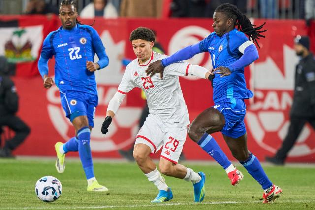 Tunisia's forward #29 Louey Ben Farhat vies for the ball with Haiti's defender #22 Jean-Kevin Duverne and Haiti's defender #04 Ricardo Ade during a friendly football match between Haiti and Tunisia at BMO Field in Toronto, Canada, on March 28, 2026. (Photo by Geoff Robins / AFP)