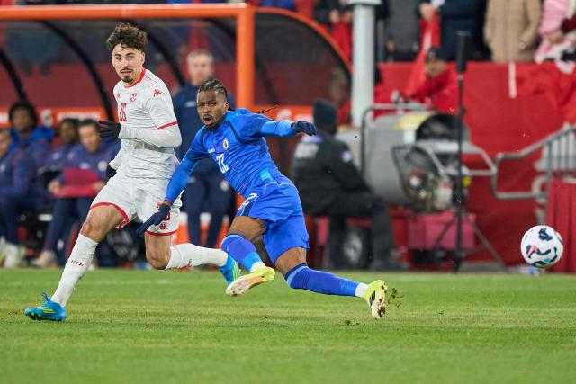 Tunisia's forward #26 Sebastian Tounekti and Haiti's defender #22 Jean-Kevin Duverne vie for the ball during a friendly football match between Haiti and Tunisia at BMO Field in Toronto, Canada, on March 28, 2026. (Photo by Geoff Robins / AFP)