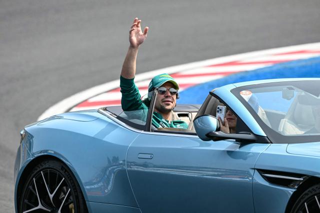 Aston Martin's Canadian driver Lance Stroll waves during the drivers' parade before the Formula One Japanese Grand Prix at the Suzuka circuit in Suzuka, Mie prefecture on March 29, 2026. (Photo by Toshifumi KITAMURA / AFP)