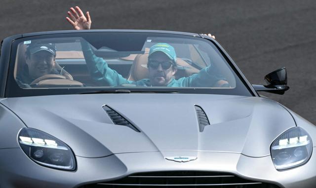 Aston Martin's Spanish driver Fernando Alonso waves during the drivers' parade before the Formula One Japanese Grand Prix at the Suzuka circuit in Suzuka, Mie prefecture on March 29, 2026. (Photo by Toshifumi KITAMURA / AFP)