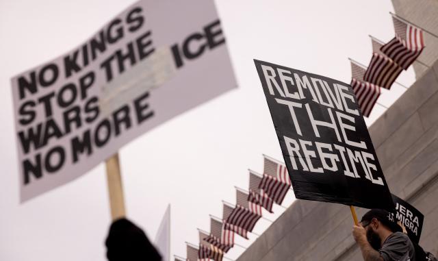 Demonstrators hold signs as they march during the "No Kings" national day of protest in Los Angeles on March 28, 2026. Nationwide protests against US President Donald Trump are expected Saturday as millions of people vent fury over what they see as his authoritarian bent and other forms of cruel, law-trampling governance. It is the third time in less than a year that Americans will take to the streets as part of a grassroots movement called "No Kings," the most vocal and visual conduit for opposition to Trump since he began his second term in January 2025. (Photo by ETIENNE LAURENT / AFP)