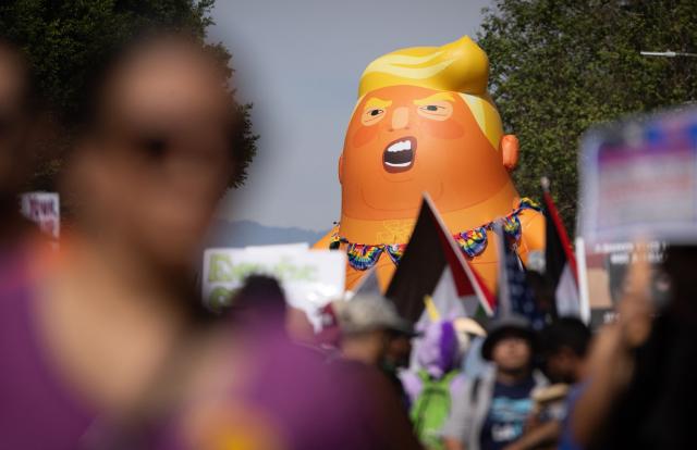 A giant inflatable balloon in the likeness of US President Donald Trump as a baby in diapers is seen as demonstrators march during the "No Kings" national day of protest in Los Angeles on March 28, 2026. Nationwide protests against US President Donald Trump are expected Saturday as millions of people vent fury over what they see as his authoritarian bent and other forms of cruel, law-trampling governance. It is the third time in less than a year that Americans will take to the streets as part of a grassroots movement called "No Kings," the most vocal and visual conduit for opposition to Trump since he began his second term in January 2025. (Photo by ETIENNE LAURENT / AFP)