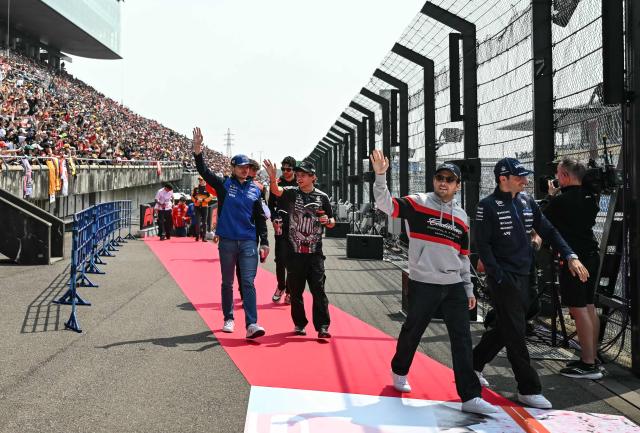 (L-R) Red Bull Racing's Dutch driver Max Verstappen, Mercedes' Italian driver Kimi Antonelli, Cadillac's Mexican driver Sergio Perez and Williams' Spanish driver Carlos Sainz arrive for the drivers' parade before the Formula One Japanese Grand Prix at the Suzuka circuit in Suzuka, Mie prefecture on March 29, 2026. (Photo by ANDREW CABALLERO-REYNOLDS / AFP)