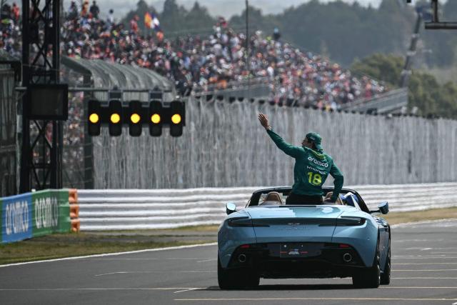 Aston Martin's Canadian driver Lance Stroll waves during the drivers' parade before the Formula One Japanese Grand Prix at the Suzuka circuit in Suzuka, Mie prefecture on March 29, 2026. (Photo by Philip FONG / AFP)