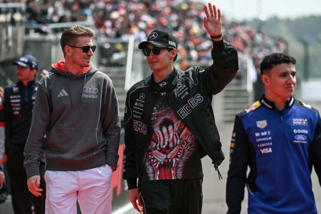 Audi's German driver Nico Hulkenberg, Mercedes' British driver George Russell and Red Bull Racing's French driver Isack Hadjar arrive for the drivers' parade before the Formula One Japanese Grand Prix at the Suzuka circuit in Suzuka, Mie prefecture on March 29, 2026. (Photo by ANDREW CABALLERO-REYNOLDS / AFP)