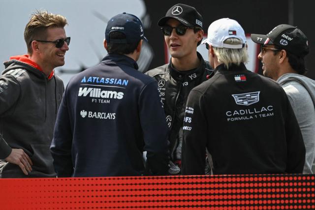 Audi's German driver Nico Hulkenberg (L), Mercedes' British driver George Russell (C) and Cadillac's Mexican driver Sergio Perez (R) attend the drivers' parade before the Formula One Japanese Grand Prix at the Suzuka circuit in Suzuka, Mie prefecture on March 29, 2026. (Photo by ANDREW CABALLERO-REYNOLDS / AFP)