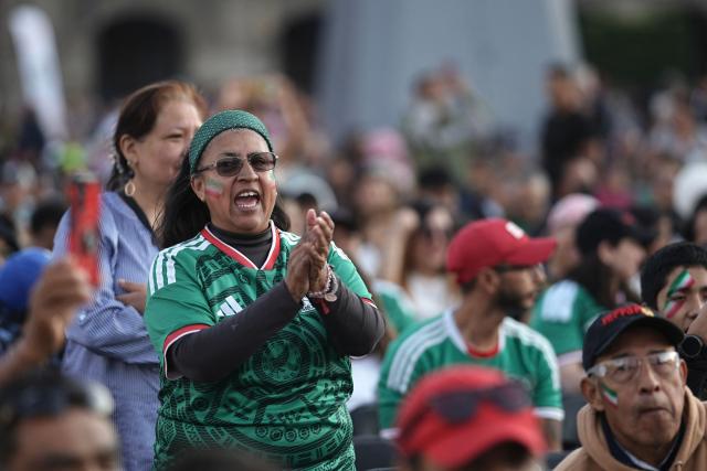 A Mexican fan cheers for her team watching a broadcast of the friendly football match between Mexico and Portugal at Zocalo square in Mexico City on March 28, 2026. (Photo by Heptor ARJONA / AFP)