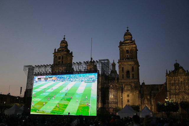 Mexican fans watch the broadcast of the friendly football match between Mexico and Portugal at Zocalo square in Mexico City on March 28, 2026. (Photo by Heptor ARJONA / AFP)
