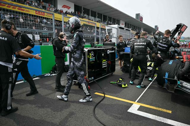Mercedes' British driver George Russell (centre L) walks before the start of the Formula One Japanese Grand Prix at the Suzuka circuit in Suzuka, Mie prefecture on March 29, 2026. (Photo by ANDREW CABALLERO-REYNOLDS / AFP)