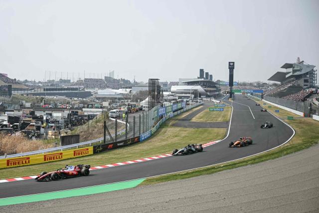 Ferrari's Monegasque driver Charles Leclerc (L) drives during the Formula One Japanese Grand Prix at the Suzuka circuit in Suzuka, Mie prefecture on March 29, 2026. (Photo by ANDREW CABALLERO-REYNOLDS / AFP)