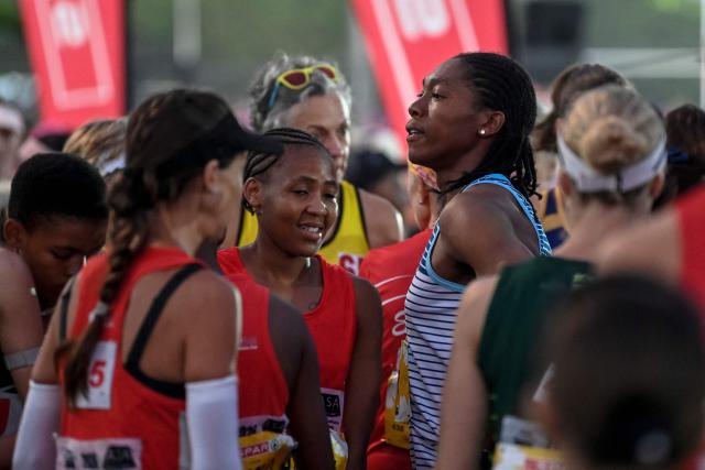 South African Olympic champion Caster Semenya (R) gathers with other runners ahead of the Cape Town SPAR Women’s 10km Challenge in Cape Town on March 29, 2026. (Photo by Rodger Bosch / AFP)