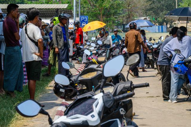 Motorists queue up to refuel their vehicles outside a petrol station in Naypyidaw on March 29, 2026. (Photo by ANTHONY WALLACE / AFP)