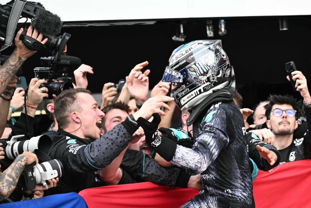 Mercedes' Italian driver Kimi Antonelli celebrates with his team at the parc ferme after winning the Formula One Japanese Grand Prix at the Suzuka circuit in Suzuka, Mie prefecture on March 29, 2026. (Photo by Philip FONG / AFP)