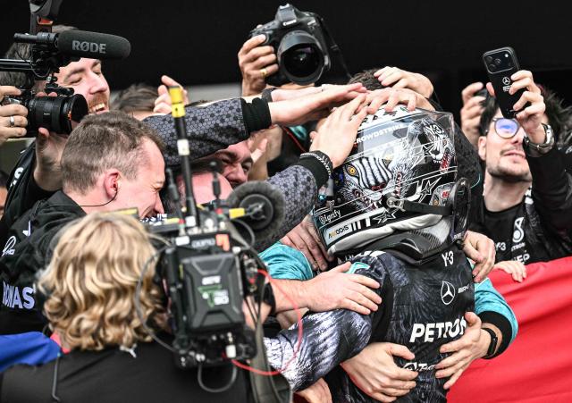 Mercedes' Italian driver Kimi Antonelli celebrates with his team at the parc ferme after winning the Formula One Japanese Grand Prix at the Suzuka circuit in Suzuka, Mie prefecture on March 29, 2026. (Photo by Philip FONG / AFP)