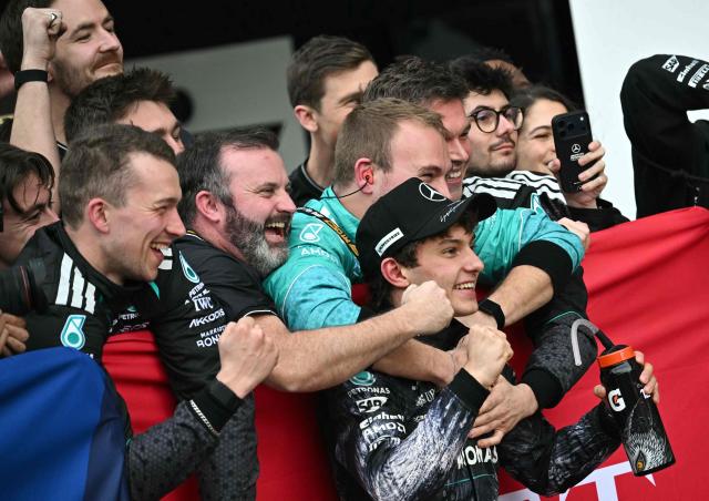 Mercedes' Italian driver Kimi Antonelli celebrates with his team at the parc ferme after winning the Formula One Japanese Grand Prix at the Suzuka circuit in Suzuka, Mie prefecture on March 29, 2026. (Photo by Philip FONG / AFP)