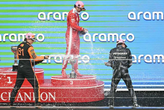 Winner Mercedes' Italian driver Kimi Antonelli (R), second-placed McLaren's Australian driver Oscar Piastri (L) and third-placed Ferrari's Monegasque driver Charles Leclerc (C) celebrate on the podium after the Formula One Japanese Grand Prix at the Suzuka circuit in Suzuka, Mie prefecture on March 29, 2026. (Photo by ANDREW CABALLERO-REYNOLDS / AFP)