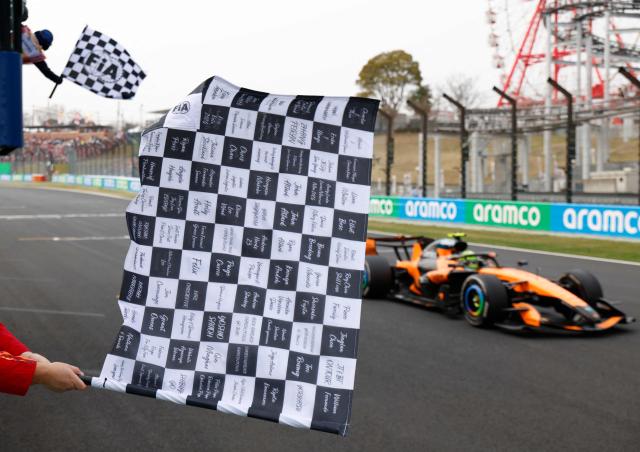 McLaren's Australian driver Oscar Piastri crosses the finish line to win the Formula One Japanese Grand Prix at the Suzuka circuit in Suzuka, Mie prefecture on March 29, 2026. (Photo by FRANCK ROBICHON / POOL / AFP)