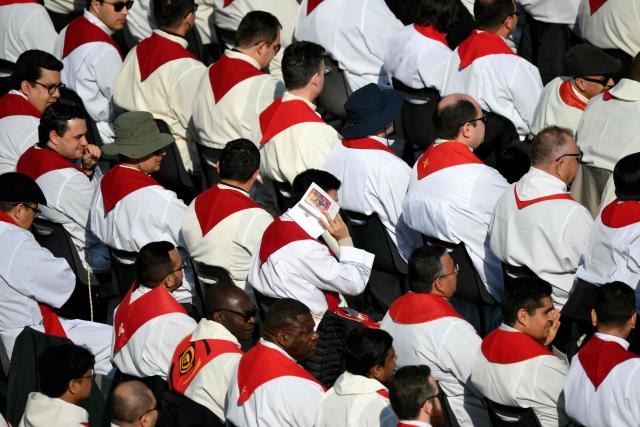 Clergymen wait before a mass for Palm Sunday by Pope Leo XIV at St Peter's square in the Vatican on March 29, 2026. (Photo by Marco BERTORELLO / AFP)