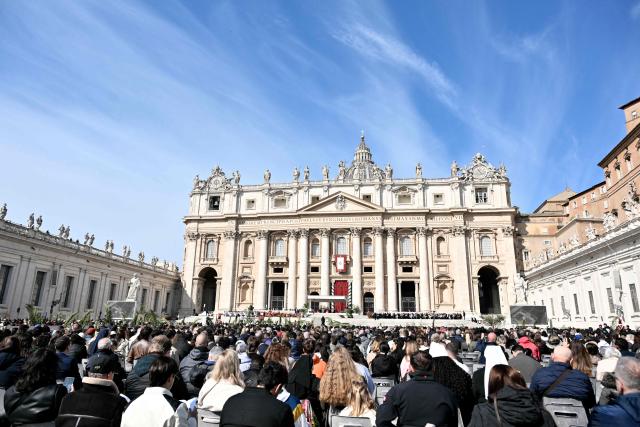 Worshippers attend a mass for Palm Sunday by Pope Leo XIV at St Peter's square in the Vatican on March 29, 2026. (Photo by Tiziana FABI / AFP)
