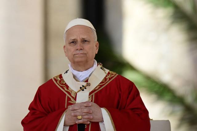 Pope Leo XIV leads a mass for Palm Sunday at St Peter's square in the Vatican on March 29, 2026. (Photo by Tiziana FABI / AFP)