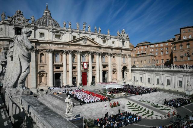 People attend a mass for Palm Sunday led by Pope Leo XIV at St Peter's square in the Vatican on March 29, 2026. (Photo by Marco BERTORELLO / AFP)