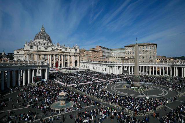 People attend a mass for Palm Sunday led by Pope Leo XIV at St Peter's square in the Vatican on March 29, 2026. (Photo by Marco BERTORELLO / AFP)