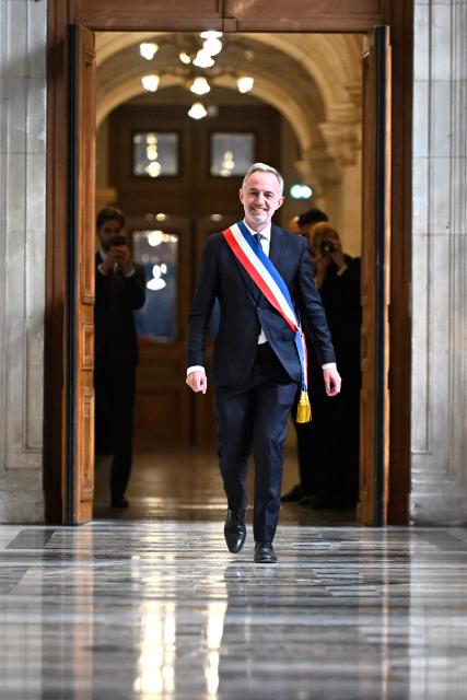 Paris' newly elected Mayor Emmanuel Grégoire wears the tricolour mayoral sash after being nominated during the inaugural city council session at the city hall of Paris on March 29, 2026. Emmanuel Grégoire, who was elected mayor of Paris by a wide margin over right wing candidate Rachida Dati, takes office on March 29, 2026 at the Paris City Hall to succeed Anne Hidalgo, who is stepping down after 12 years in office. (Photo by JULIEN DE ROSA / POOL / AFP)