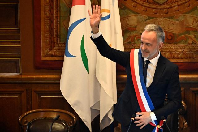 Paris' newly elected Mayor Emmanuel Grégoire wearing tricolour mayoral sash after being nominated greets the council during the inaugural city council session at the city hall of Paris on March 29, 2026. Emmanuel Grégoire, who was elected mayor of Paris by a wide margin over right wing candidate Rachida Dati, takes office on March 29, 2026 at the Paris City Hall to succeed Anne Hidalgo, who is stepping down after 12 years in office. (Photo by JULIEN DE ROSA / AFP)