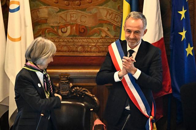 Paris' newly elected Mayor Emmanuel Grégoire wearing tricolour mayoral sash after being nominated greets the council during the inaugural city council session at the city hall of Paris on March 29, 2026. Emmanuel Grégoire, who was elected mayor of Paris by a wide margin over right wing candidate Rachida Dati, takes office on March 29, 2026 at the Paris City Hall to succeed Anne Hidalgo, who is stepping down after 12 years in office. (Photo by JULIEN DE ROSA / AFP)