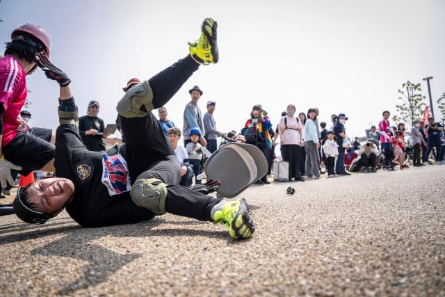 A racer falls during the qualifiers of the ISU-1 Grand Prix in Kyotanabe, Kyoto Prefecture on March 29, 2026. The ISU-1 Grand Prix is an endurance race supervised by the Japan Office Chair Racing Association (JORA), in which participants compete to see how many laps they can complete on office chairs over two hours. The event originated in 2010 in the Kirara shopping district of Kyotanabe, Kyoto Prefecture, and is now held at more than 20 locations across Japan. (Photo by Yuichi YAMAZAKI / AFP)