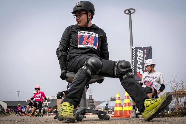 Racers riding on office chairs compete in the ISU-1 Grand Prix in Kyotanabe, Kyoto prefecture on March 29, 2026. The ISU-1 Grand Prix is an endurance race supervised by the Japan Office Chair Racing Association (JORA), in which participants compete to see how many laps they can complete on office chairs over two hours. The event originated in 2010 in the Kirara shopping district of Kyotanabe, Kyoto Prefecture, and is now held at more than 20 locations across Japan. (Photo by Yuichi YAMAZAKI / AFP)