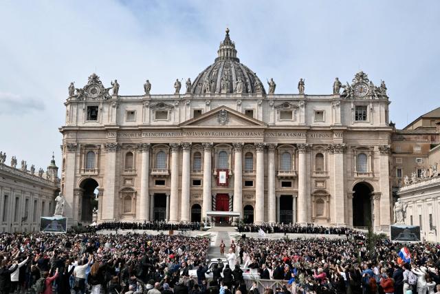 Pope Leo XIV greets the crowd as he leaves after the Palm Sunday mass at St Peter's square in the Vatican on March 29, 2026. (Photo by Tiziana FABI / AFP)