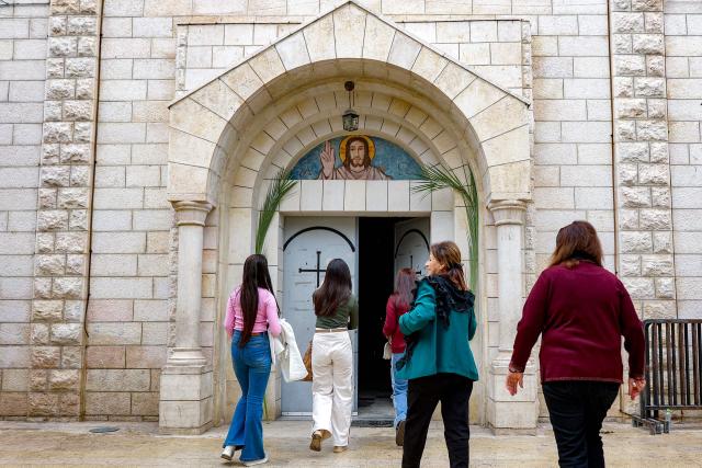 Faithful arrive for the Palm Sunday service at the Roman Catholic Church of the Holy Family in Gaza City on March 29, 2026. (Photo by Omar AL-QATTAA / AFP)
