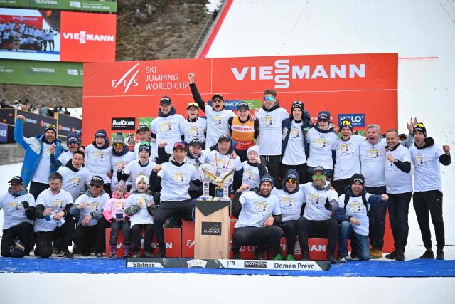 Team Slovenia members celebrate with their trophies on the podium after the Men's Individual Large Hill event at the FIS Jumping World Cup in Planica on March 29, 2026. (Photo by JURE MAKOVEC / AFP)