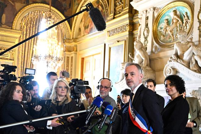 Paris' newly elected Mayor Emmanuel Grégoire, wearing his tricolour mayoral sash, speaks to journalists, next to his first deputy mayor Lamia El Aaraje (R), after the inaugural city council session at the city hall of Paris on March 29, 2026. Emmanuel Grégoire, who was elected mayor of Paris by a wide margin over right wing candidate Rachida Dati, takes office on March 29, 2026 at the Paris City Hall to succeed Anne Hidalgo, who is stepping down after 12 years in office. (Photo by JULIEN DE ROSA / AFP)