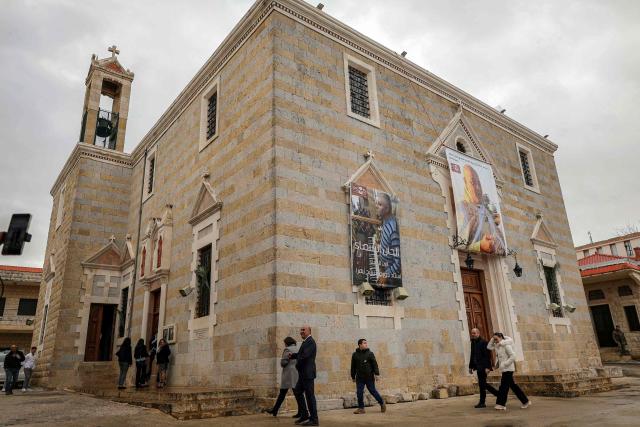 People arrive for the Palm Sunday service at the Maronite Church of Saint George in the southern Lebanese border Christian village of Qlayaa on March 29, 2026. (Photo by AFP)