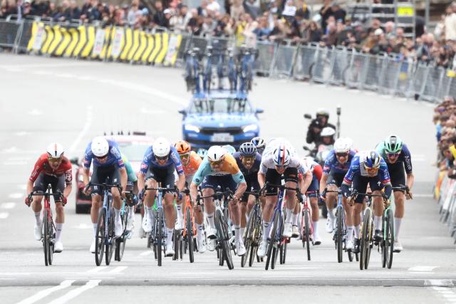 Team NSN Cycling Team's Australian rider Brady Gilmore (C) competes with Team Ineos' French rider Dorian Godon (C,R) before crossing first the finish line of the seventh and last stage of the 2026 'Volta a Catalunya' cycling tour of Catalonia, a 95,1 km race between Barcelona and Barcelona, on March 29, 2026. (Photo by Josep LAGO / AFP)