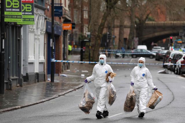 Police forensic officers take away full evidence bags on Friar Gate in central Derby, central England on March 29, 2026, following an incident the night before where a vehicle was driven into pedestrians. British police said they arrested a man after a car struck several pedestrians in a city in central England on Saturday night, leaving some victims seriously injured. (Photo by Darren Staples / AFP)