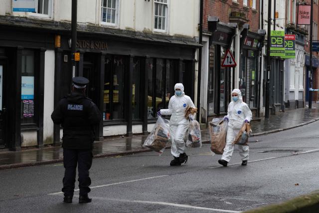 Police forensic officers take away full evidence bags on Friar Gate in central Derby, central England on March 29, 2026, following an incident the night before where a vehicle was driven into pedestrians. British police said they arrested a man after a car struck several pedestrians in a city in central England on Saturday night, leaving some victims seriously injured. (Photo by Darren Staples / AFP)