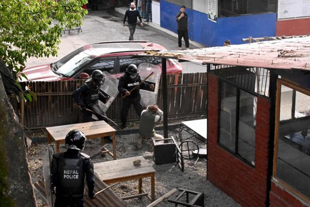 Police personnel clash with supporters of Nepal's former prime minister Khadga Prasad Sharma Oli, to protest against his arrest in Kathmandu on March 29, 2026. Oli appeared in court via video-link from a hospital on March 29 after his arrest for his alleged role in a deadly crackdown on the 2025 protests that ousted him. (Photo by Prakash MATHEMA / AFP)