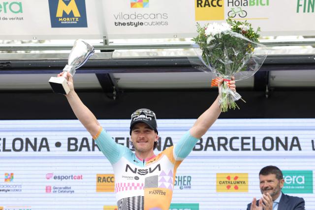 Team NSN Cycling Team's Australian rider Brady Gilmore celebrates on the podium winning the seventh and last stage of the 2026 'Volta a Catalunya' cycling tour of Catalonia, a 95,1 km race between Barcelona and Barcelona, on March 29, 2026. (Photo by Josep LAGO / AFP)