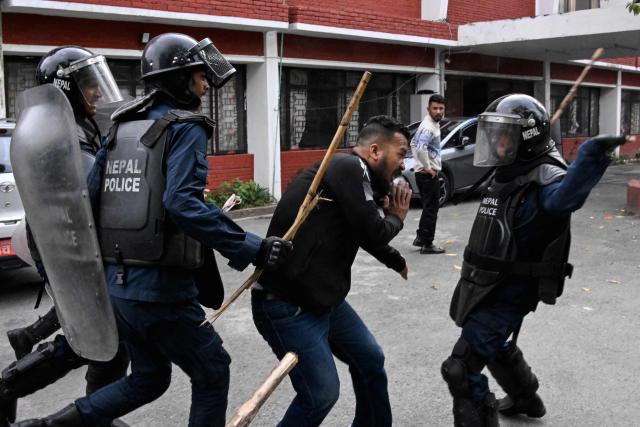 Police personnel clash with supporters of Nepal's former prime minister Khadga Prasad Sharma Oli, to protest against his arrest in Kathmandu on March 29, 2026. A Nepal court on March 29 extended by five days the detention of Oli and his home minister after their arrest over alleged involvement in a deadly crackdown on the 2025 protests that ousted him. (Photo by Prakash MATHEMA / AFP)
