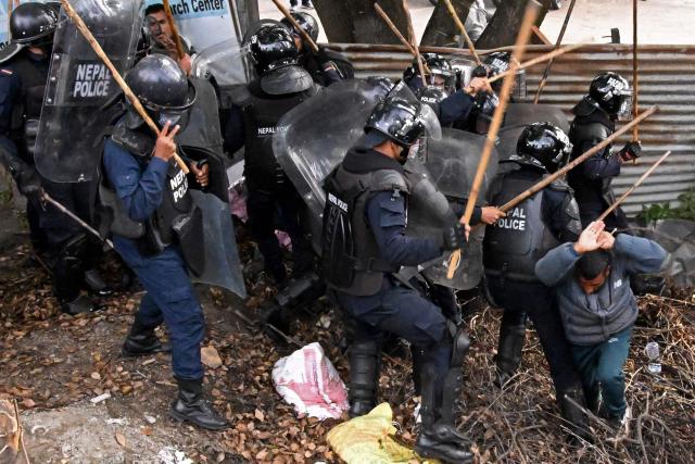 Police personnel clash with supporters of Nepal's former prime minister Khadga Prasad Sharma Oli, during a protest against his arrest in Kathmandu on March 29, 2026. A Nepal court on March 29 extended by five days the detention of Oli and his home minister after their arrest over alleged involvement in a deadly crackdown on the 2025 protests that ousted him. (Photo by Prakash MATHEMA / AFP)